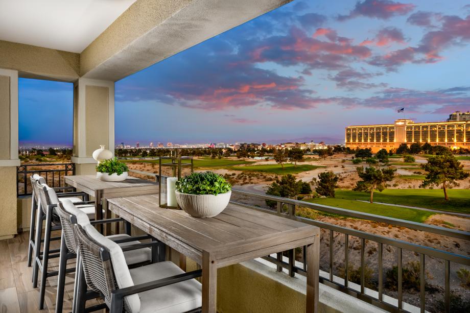 Balcony overlooking golf course and illuminated resort at dusk