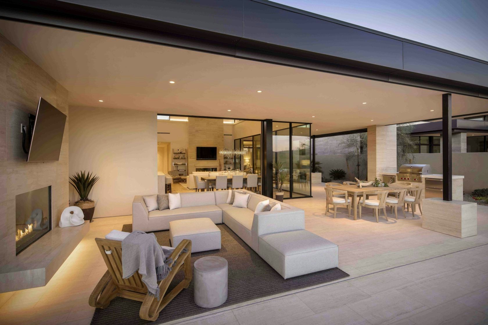 Covered outdoor terrace with lounge seating and outdoor kitchen