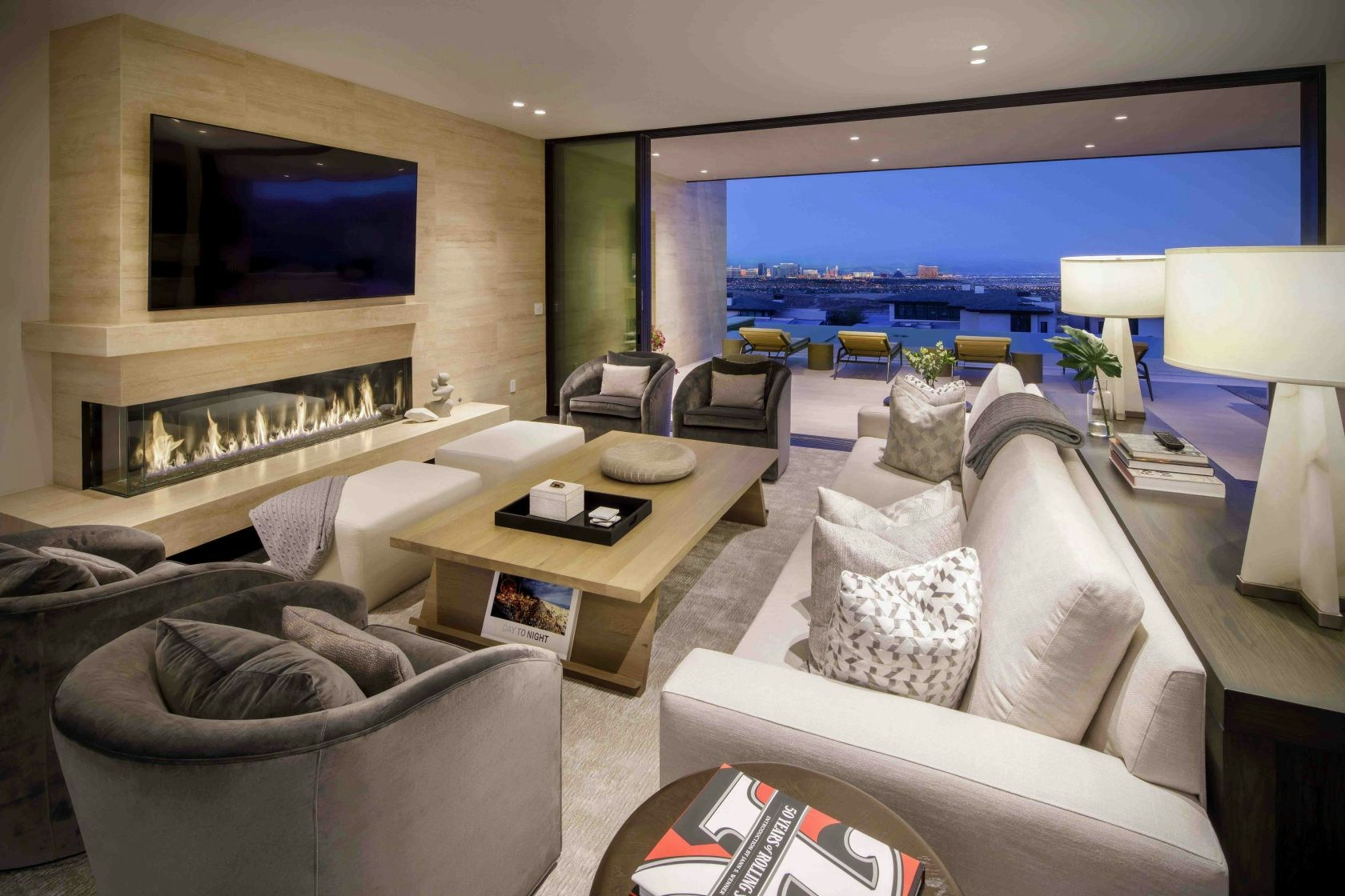 Great room with linear fireplace and city views