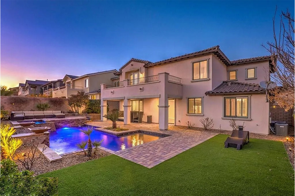 Twilight rear elevation with pool and landscaping